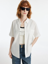 a lady in a casual lapel white short sleeves shirt